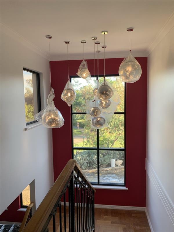 Pendant lighting installation above a staircase
